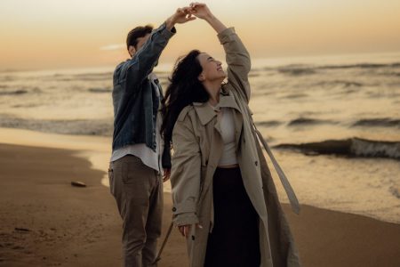 Couple dances together romantically on the beach.